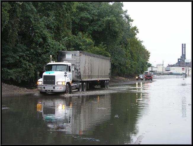 Truck negotiates flood water on Flat Rock Road