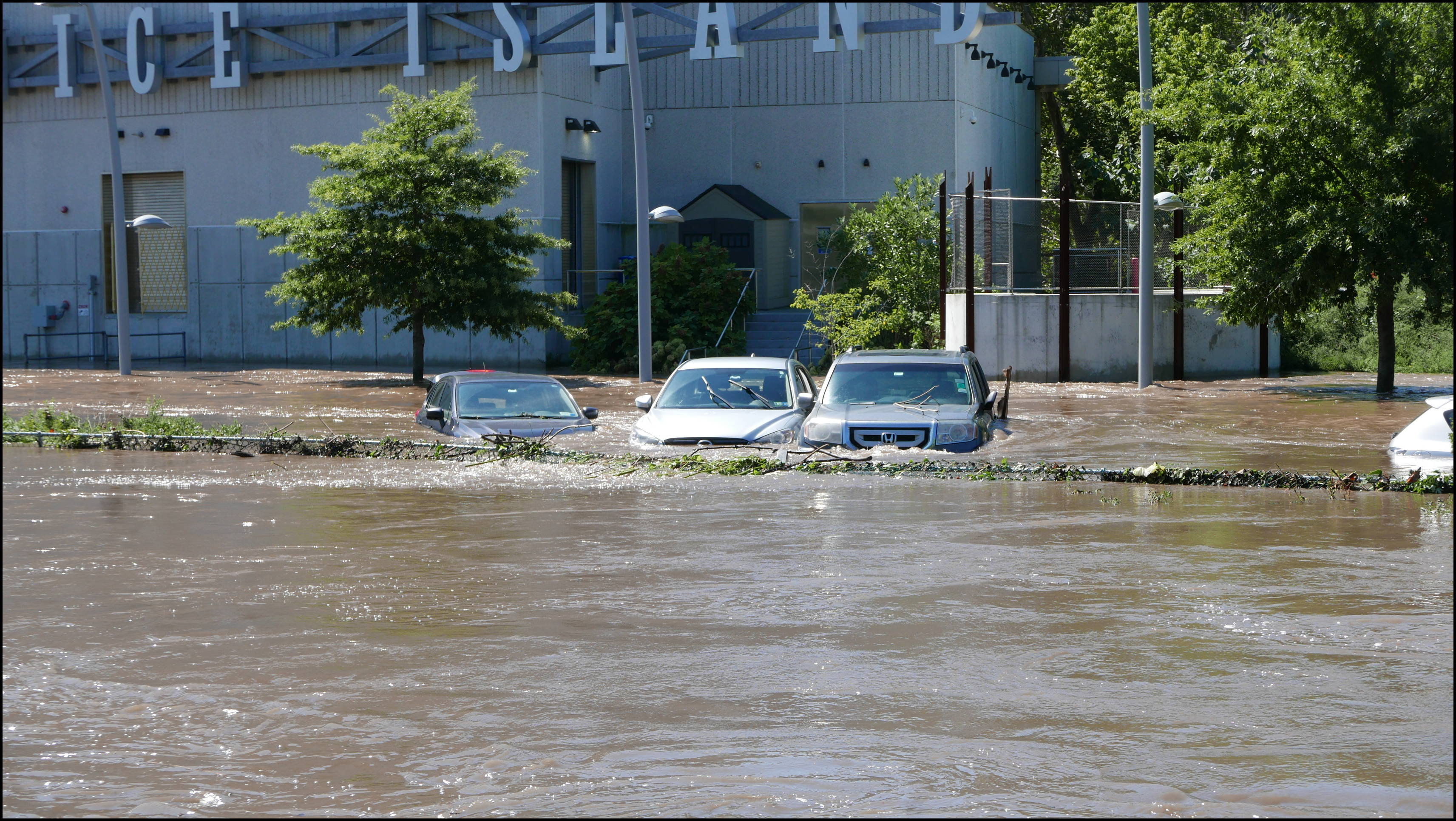 Cotton Street and the canal -- Flooded cars in the Rec Center parking lot