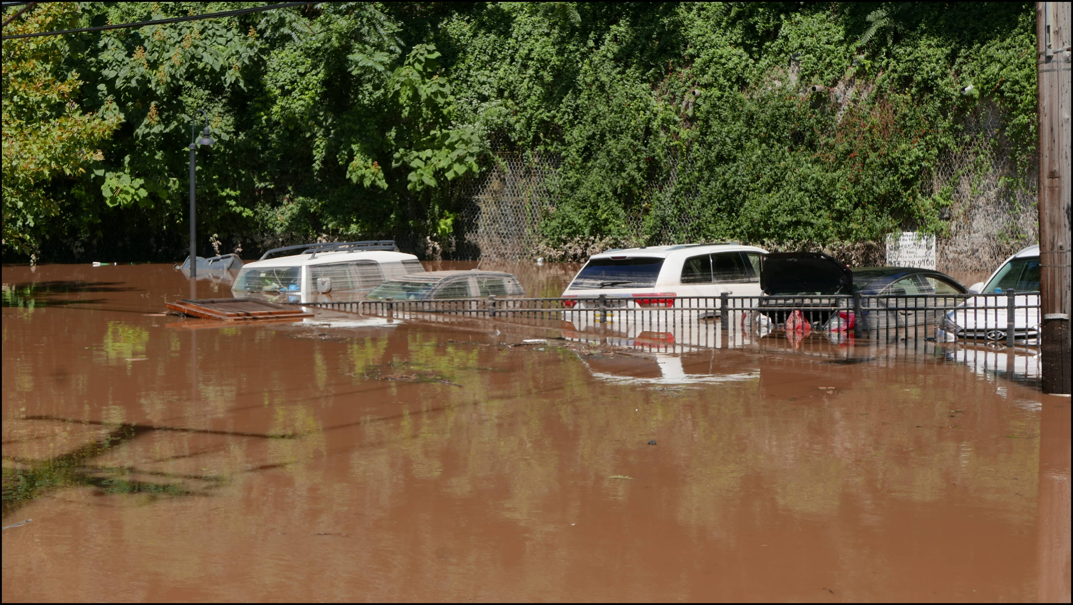 Southern limit of flooding on Main Street -- Flooded cars in the Yarn Factory Lofts (Wilde Yarn) parking lot.