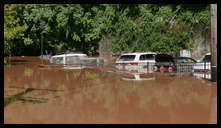 Southern limit of flooding on Main Street -- Flooded cars in the Yarn Factory Lofts (Wilde Yarn) parking lot.